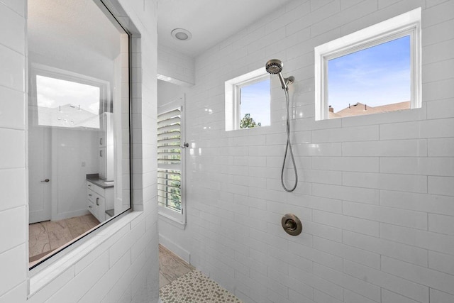 203 Black Stone Cv, Driftwood, TX 78619 - full bathroom with a tile shower and healthy amount of natural light