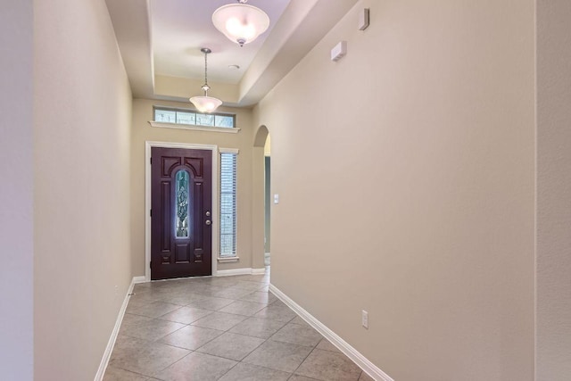 9728 Alex Ln, Austin, TX 78748 - entrance foyer featuring arched walkways, light tile patterned flooring, and a tray ceiling