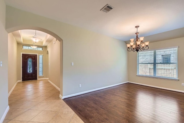 9728 Alex Ln, Austin, TX 78748 - foyer featuring a chandelier, arched walkways, and light tile patterned floors