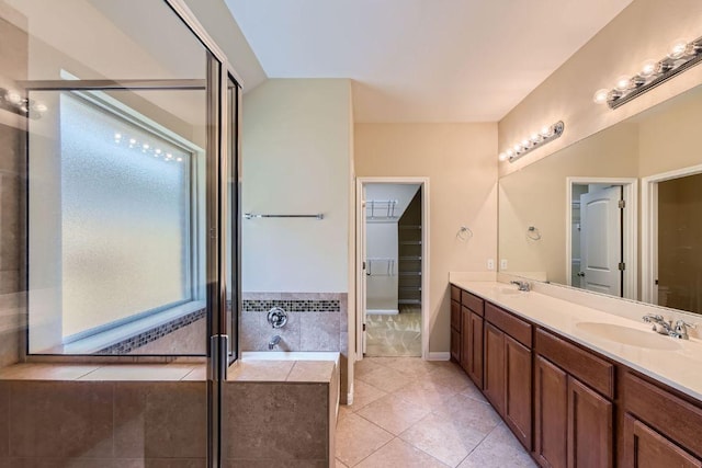 9728 Alex Ln, Austin, TX 78748 - full bathroom with double vanity, a shower stall, tile patterned floors, a bath, and a spacious closet