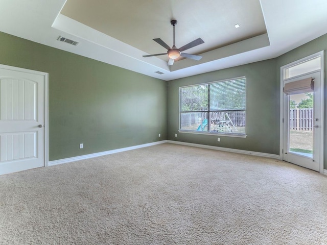 100 N Meadowlark St, Lakeway, TX 78734 - carpeted spare room featuring a tray ceiling and a ceiling fan