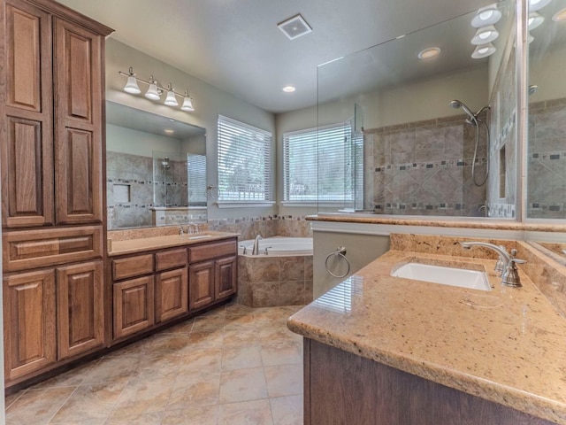 100 N Meadowlark St, Lakeway, TX 78734 - bathroom with tiled shower, two vanities, a garden tub, and tile patterned flooring