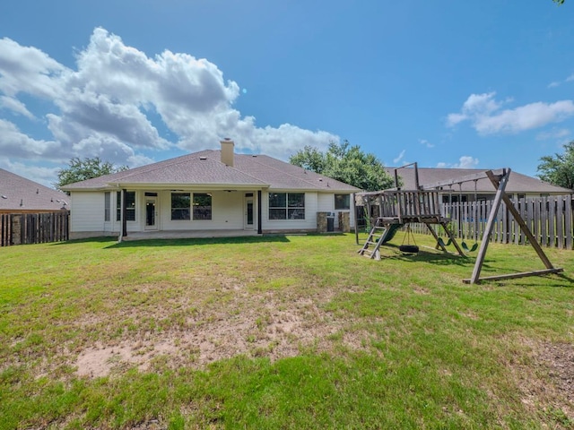 100 N Meadowlark St, Lakeway, TX 78734 - back of house with a playground, a fenced backyard, a patio area, and a chimney