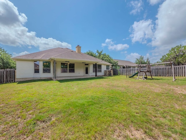 100 N Meadowlark St, Lakeway, TX 78734 - rear view of property with a playground, a fenced backyard, ceiling fan, and a chimney