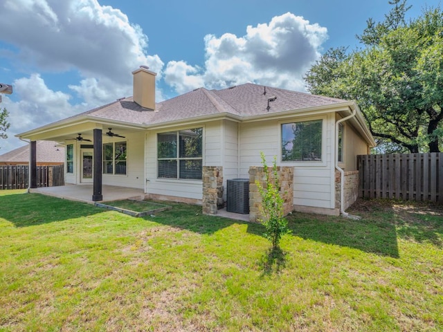 100 N Meadowlark St, Lakeway, TX 78734 - back of property featuring ceiling fan, a patio area, a chimney, and stone siding