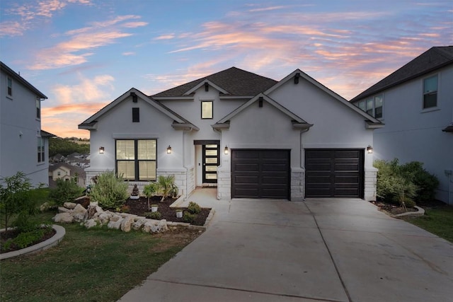 1332 Al Fresco Cv, Leander, TX 78641 - view of front of home with stucco siding, concrete driveway, stone siding, and an attached garage