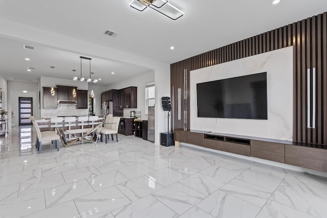 1332 Al Fresco Cv, Leander, TX 78641 - living area featuring an accent wall, recessed lighting, and light marble finish floors