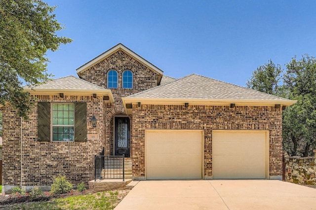 851 Catalina Ln, Austin, TX 78737 - view of front of home featuring a garage, concrete driveway, brick siding, and roof with shingles
