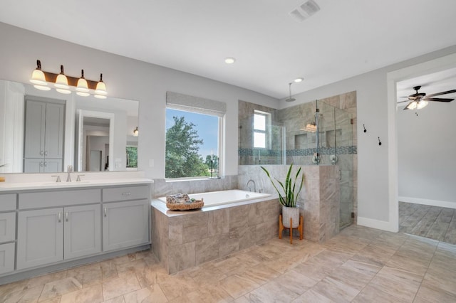 213 Woodland Hills Dr, Georgetown, TX 78633 - bathroom featuring a shower stall, vanity, a bath, and a ceiling fan