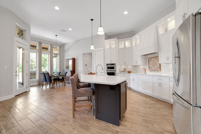213 Woodland Hills Dr, Georgetown, TX 78633 - kitchen with appliances with stainless steel finishes, light countertops, decorative backsplash, recessed lighting, and decorative light fixtures