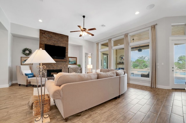 213 Woodland Hills Dr, Georgetown, TX 78633 - living area featuring a stone fireplace, light wood-style flooring, a ceiling fan, and recessed lighting