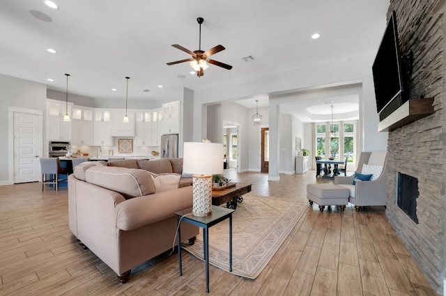 213 Woodland Hills Dr, Georgetown, TX 78633 - living room featuring ceiling fan, light wood-style floors, recessed lighting, and a stone fireplace