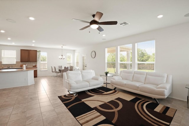 538 Thunder Valley Trl, Georgetown, TX 78626 - living room with plenty of natural light, light tile patterned floors, recessed lighting, ceiling fan, and a chandelier