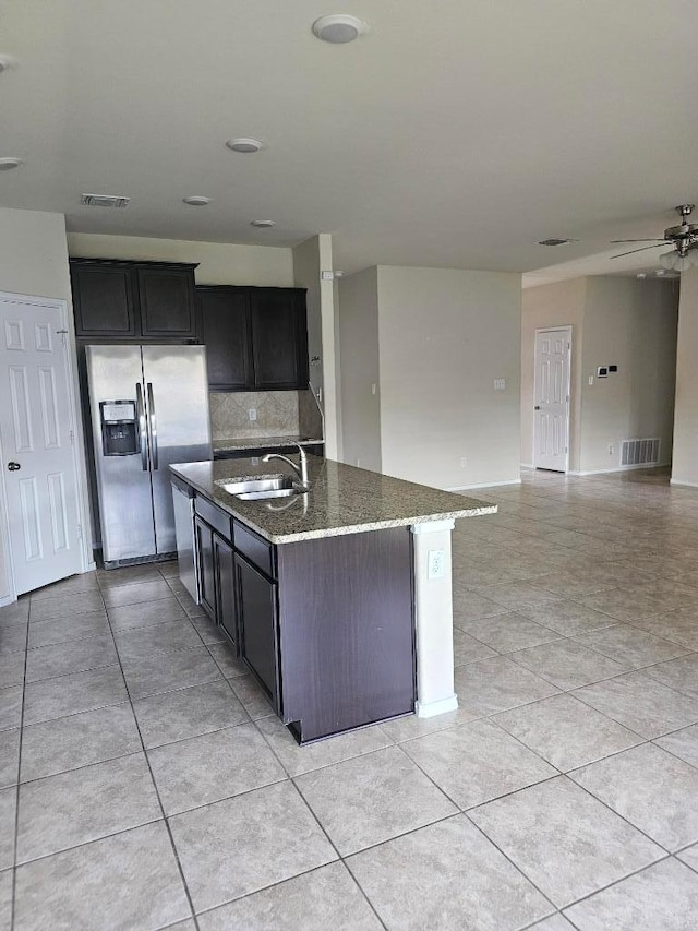 9405 Glynhill Ct, Killeen, TX 76542 - kitchen featuring stainless steel fridge, dark stone countertops, tasteful backsplash, ceiling fan, and light tile patterned flooring