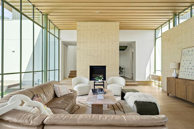 4506 Chiappero Trl, Austin, TX 78731 - living room with wood finished floors, wood ceiling, expansive windows, and a fireplace
