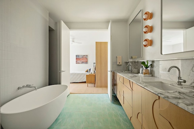 4506 Chiappero Trl, Austin, TX 78731 - ensuite bathroom featuring double vanity, a soaking tub, and decorative backsplash