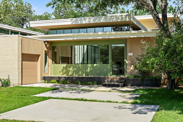4506 Chiappero Trl, Austin, TX 78731 - view of front of home with an attached garage, a front yard, and entry steps