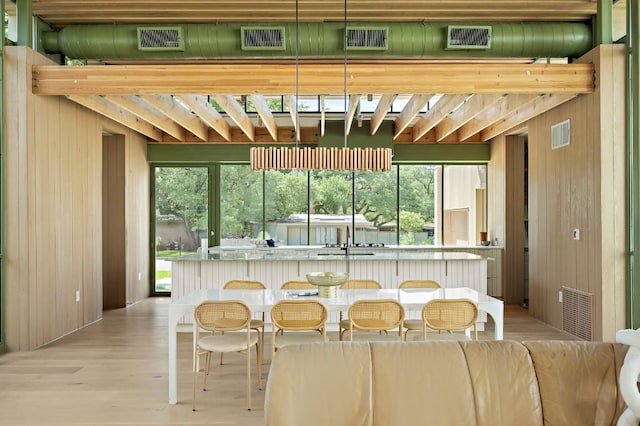 4506 Chiappero Trl, Austin, TX 78731 - kitchen with wooden walls and light wood-style flooring