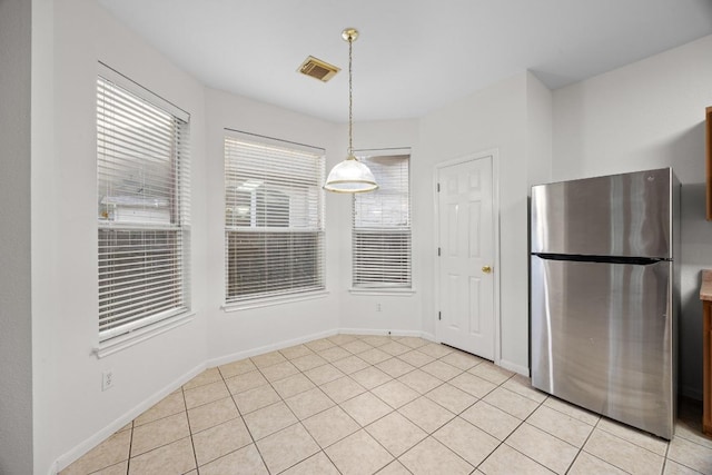 716 Bent Wood Pl, Round Rock, TX 78665 - kitchen featuring freestanding refrigerator, pendant lighting, and light tile patterned floors