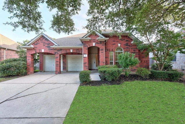 716 Bent Wood Pl, Round Rock, TX 78665 - traditional home featuring brick siding, driveway, a garage, and a front lawn