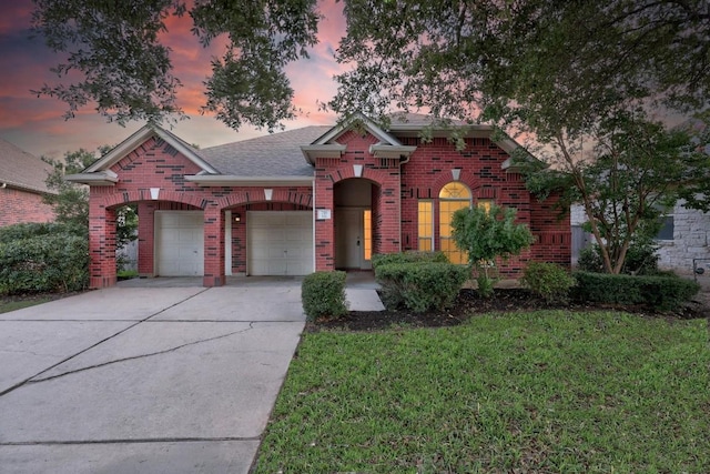 716 Bent Wood Pl, Round Rock, TX 78665 - view of front of house featuring brick siding, concrete driveway, an attached garage, and a lawn