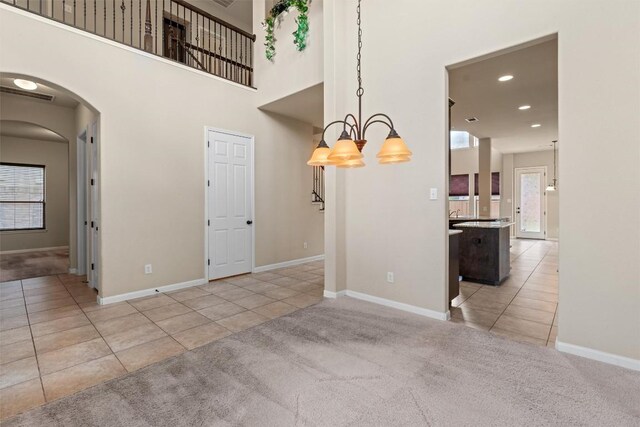 100 Calima Cv, Round Rock, TX 78681 - tiled spare room with arched walkways, a chandelier, carpet flooring, and recessed lighting