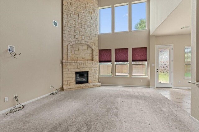 100 Calima Cv, Round Rock, TX 78681 - unfurnished living room featuring carpet floors, a fireplace, and a towering ceiling