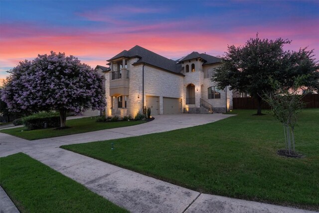 100 Calima Cv, Round Rock, TX 78681 - french provincial home featuring stone siding, a balcony, a yard, driveway, and a garage