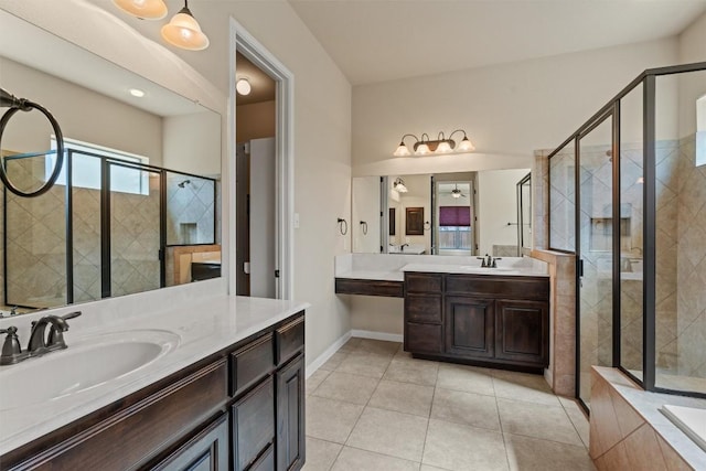 100 Calima Cv, Round Rock, TX 78681 - full bathroom with two vanities, a shower stall, tile patterned floors, and a relaxing tiled tub