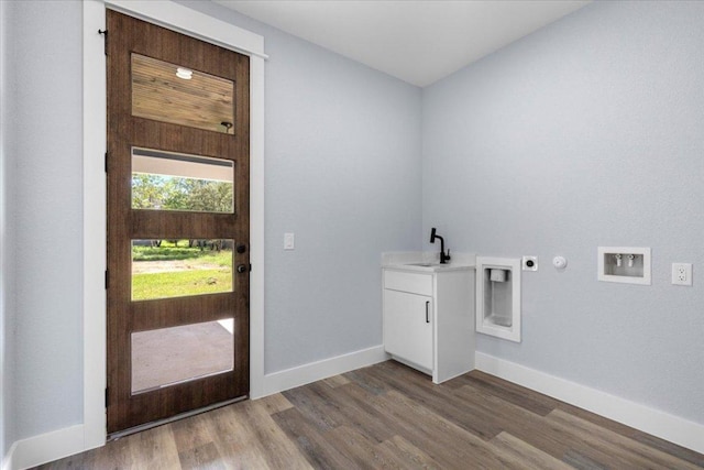 103 W Pauwela Ln, Bastrop, TX 78602 - laundry area featuring cabinet space, electric dryer hookup, dark wood-style floors, hookup for a washing machine, and hookup for a gas dryer