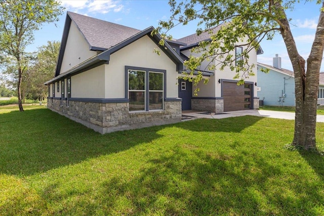 103 W Pauwela Ln, Bastrop, TX 78602 - view of front of property featuring stone siding, concrete driveway, stucco siding, and a front lawn