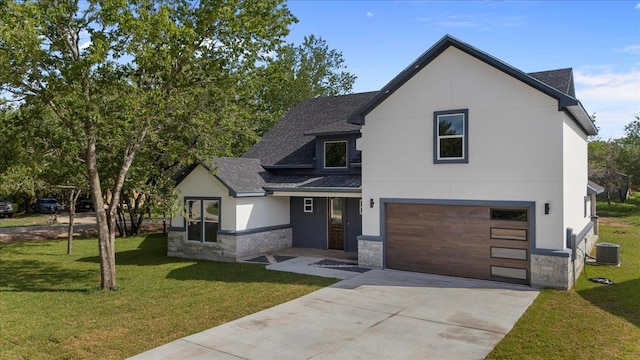 103 W Pauwela Ln, Bastrop, TX 78602 - view of front facade featuring stone siding, roof with shingles, an attached garage, and driveway