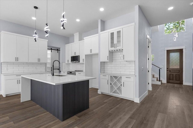 103 W Pauwela Ln, Bastrop, TX 78602 - kitchen with appliances with stainless steel finishes, tasteful backsplash, white cabinets, and recessed lighting