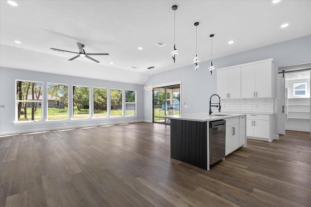 103 W Pauwela Ln, Bastrop, TX 78602 - kitchen with dishwasher, open floor plan, recessed lighting, dark wood finished floors, and a kitchen island with sink