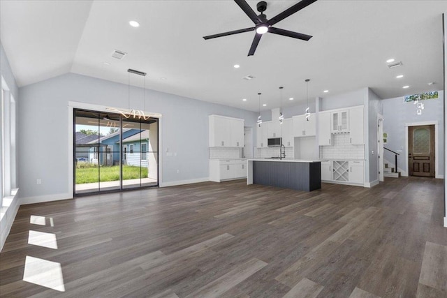 103 W Pauwela Ln, Bastrop, TX 78602 - unfurnished living room featuring ceiling fan, dark wood-type flooring, recessed lighting, and vaulted ceiling