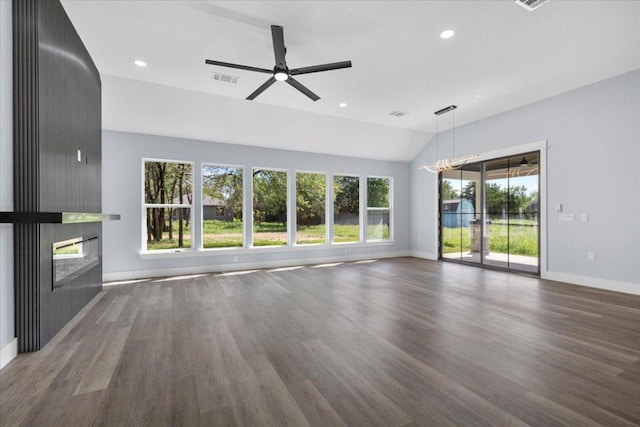 103 W Pauwela Ln, Bastrop, TX 78602 - unfurnished living room featuring a fireplace, vaulted ceiling, wood finished floors, recessed lighting, and a ceiling fan