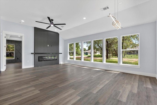 103 W Pauwela Ln, Bastrop, TX 78602 - unfurnished living room featuring wood finished floors, a large fireplace, ceiling fan, vaulted ceiling, and recessed lighting