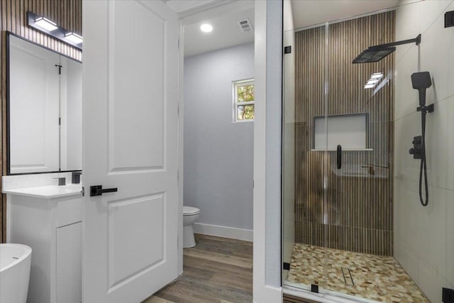 103 W Pauwela Ln, Bastrop, TX 78602 - bathroom with a stall shower, vanity, wood finished floors, and recessed lighting