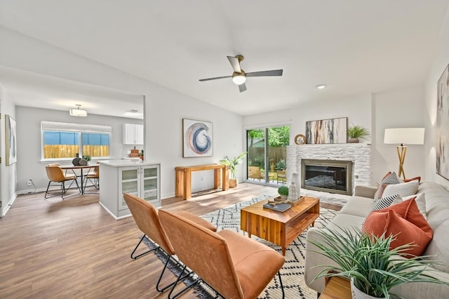 2508 Baxter Dr, Austin, TX 78745 - living area with light wood-style flooring, ceiling fan, and a glass covered fireplace