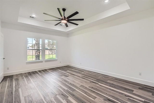 343 Nene Ln, Bastrop, TX 78602 - empty room with a raised ceiling, wood finished floors, ceiling fan, and recessed lighting