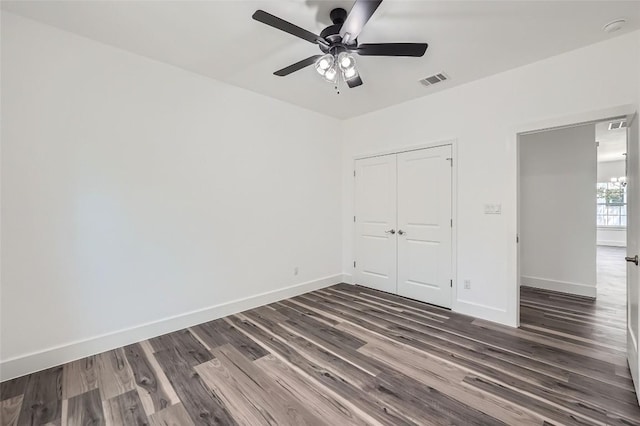 343 Nene Ln, Bastrop, TX 78602 - unfurnished bedroom featuring dark wood finished floors, a closet, and a ceiling fan