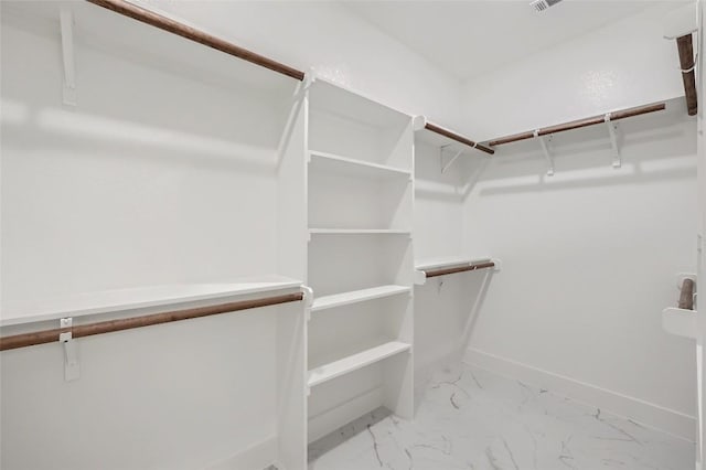 343 Nene Ln, Bastrop, TX 78602 - walk in closet featuring light marble finish flooring