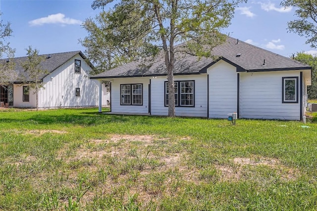 343 Nene Ln, Bastrop, TX 78602 - view of front of home featuring a front yard and a shingled roof