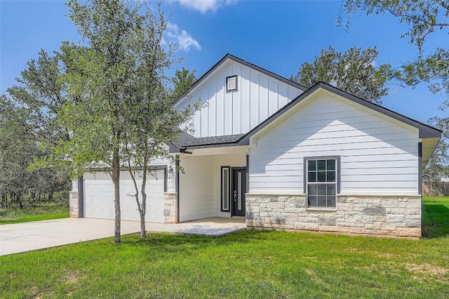 343 Nene Ln, Bastrop, TX 78602 - modern farmhouse with board and batten siding, stone siding, a front yard, and driveway