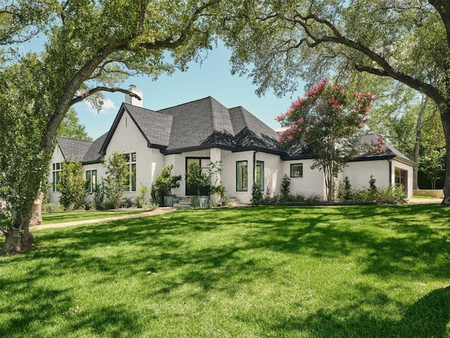 4105 Mcbrine Pl, Austin, TX 78746 - view of front of property with a chimney, stucco siding, a front lawn, and roof with shingles