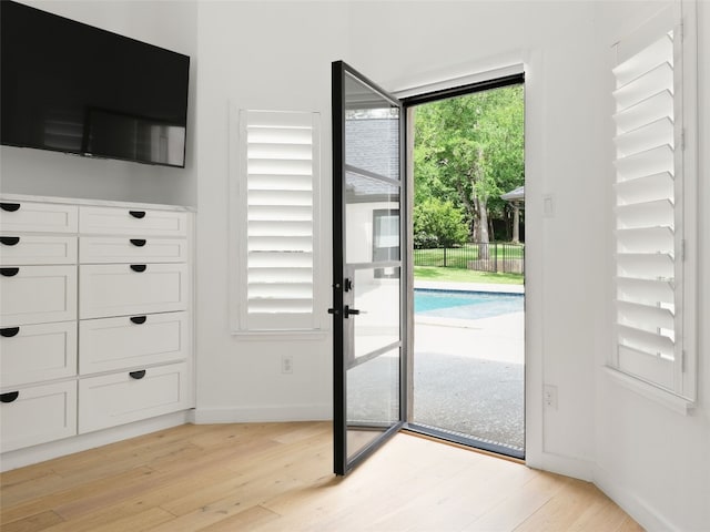 4105 Mcbrine Pl, Austin, TX 78746 - doorway with light wood-style flooring and baseboards