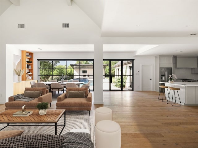 4105 Mcbrine Pl, Austin, TX 78746 - living room featuring light wood-style floors, high vaulted ceiling, beam ceiling, and recessed lighting