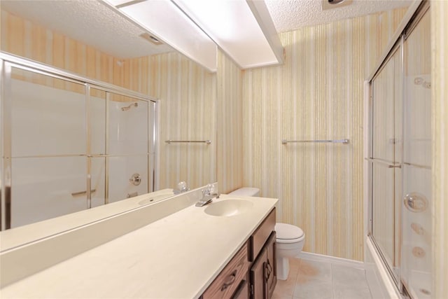 2008 Sandberg Dr, Austin, TX 78752 - full bathroom with a textured ceiling, vanity, wallpapered walls, shower / bath combination with glass door, and tile patterned flooring