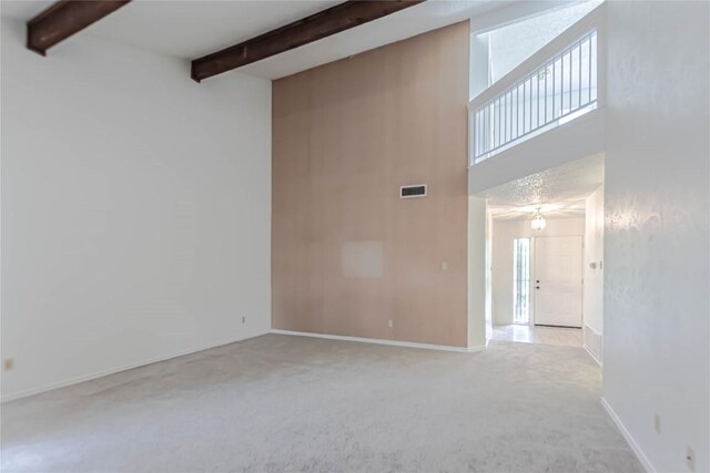 2008 Sandberg Dr, Austin, TX 78752 - carpeted empty room featuring beam ceiling and a towering ceiling