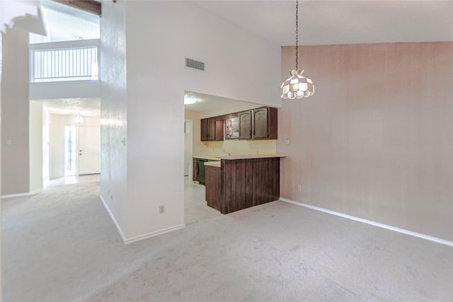 2008 Sandberg Dr, Austin, TX 78752 - unfurnished living room with a high ceiling, light carpet, and a chandelier
